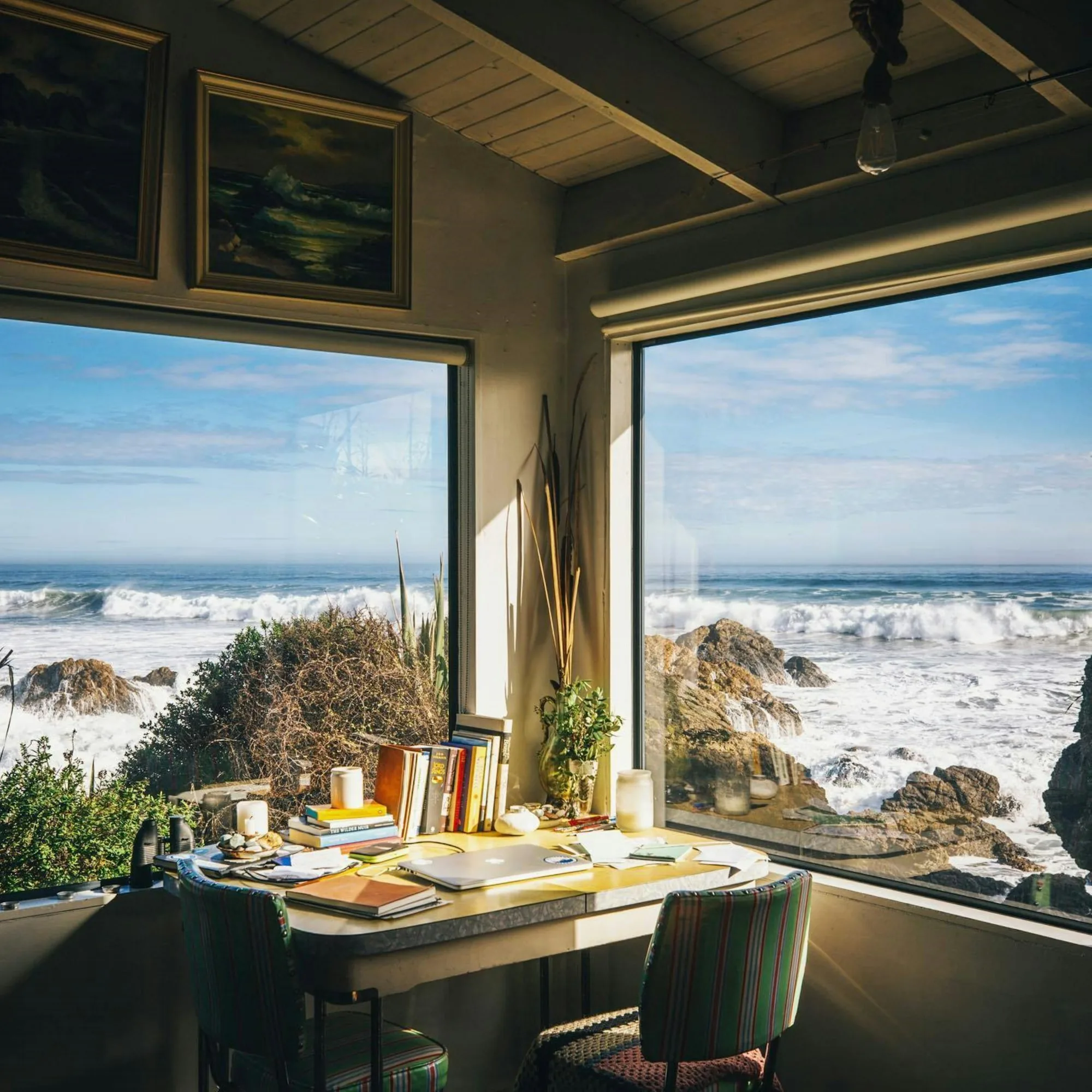 An open, light-filled workspace overlooking the coast